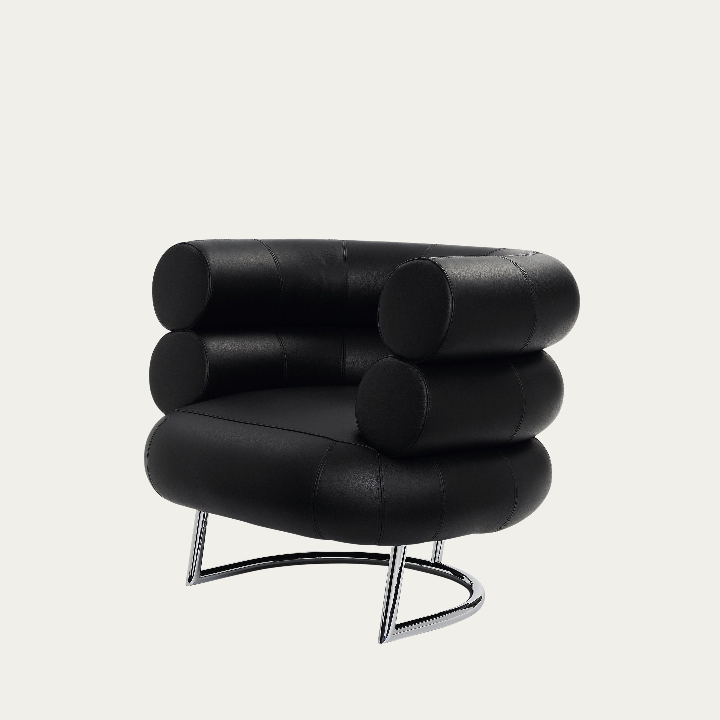 Seitenansicht des Bibendum-Stuhls von Eileen Gray (1926) mit voluminösen Kissen und elegantem Stahlgestell.